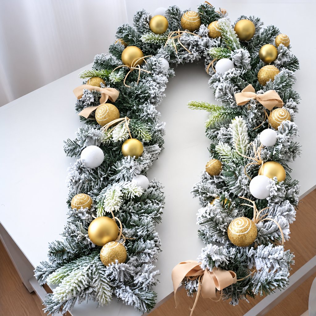 Gold decorated Christmas garland arranged on a white table