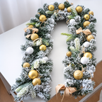 Gold decorated Christmas garland arranged on a white table