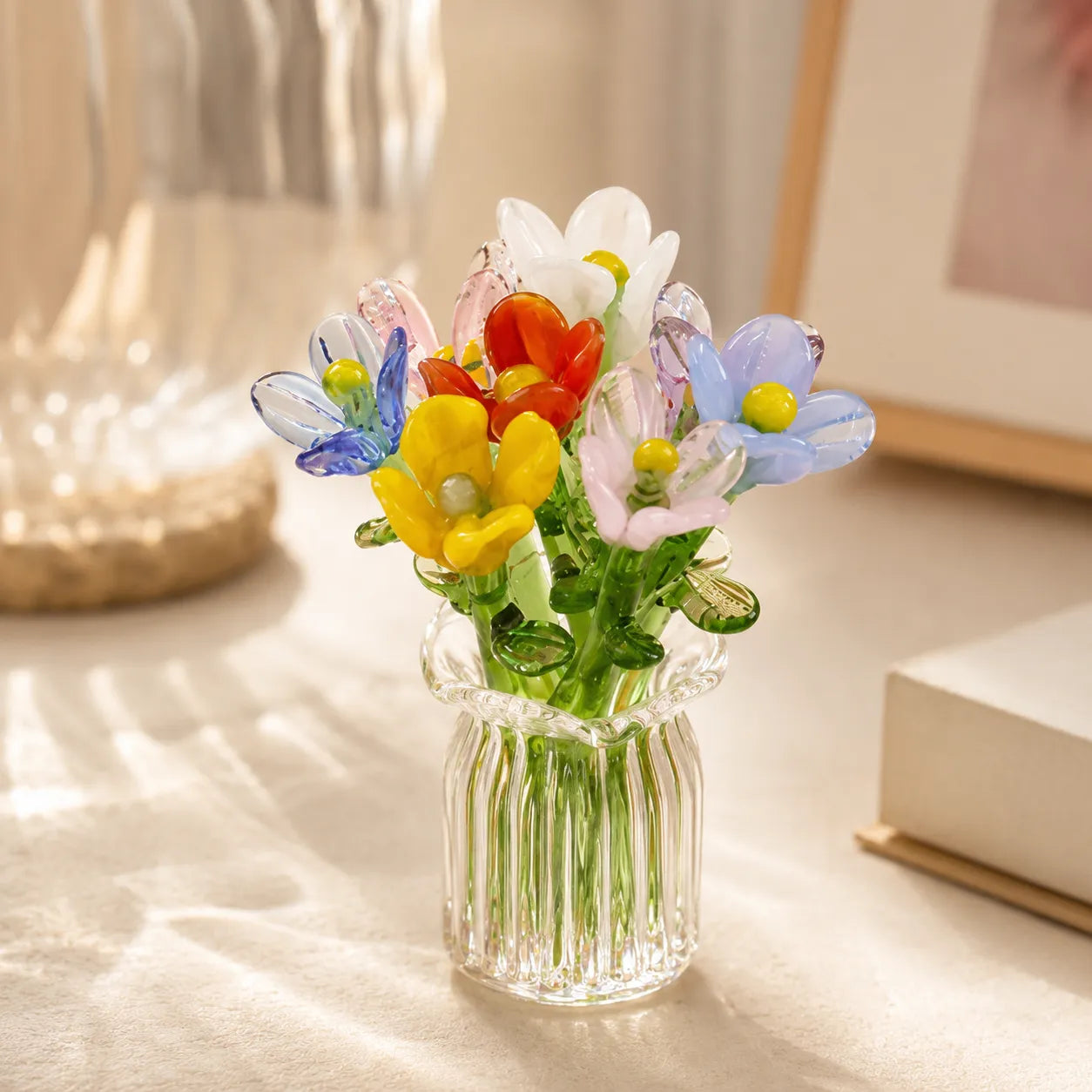 Miniature decorative glass flowers in a vase, mixed blooms