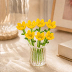 Miniature decorative glass flowers in a vase, yellow flowers