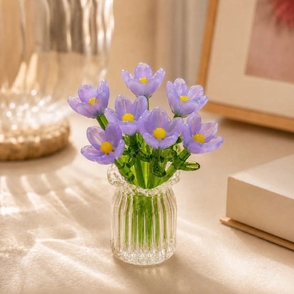 Miniature decorative glass flowers in a vase, purple flowers