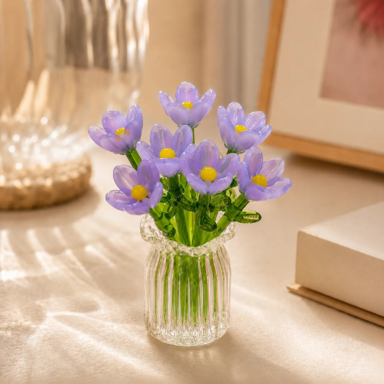 Miniature decorative glass flowers in a vase, purple flowers
