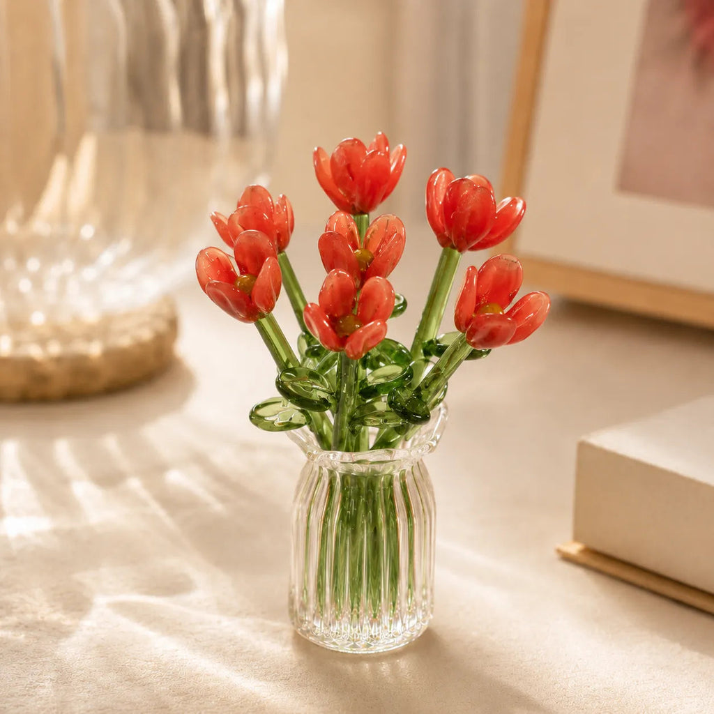 Miniature decorative glass flowers in a vase, red flowers