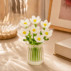 Miniature decorative glass flowers in a vase, white flowers