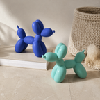 Balloon dog sculpture pair in blue and light teal near woven storage baskets