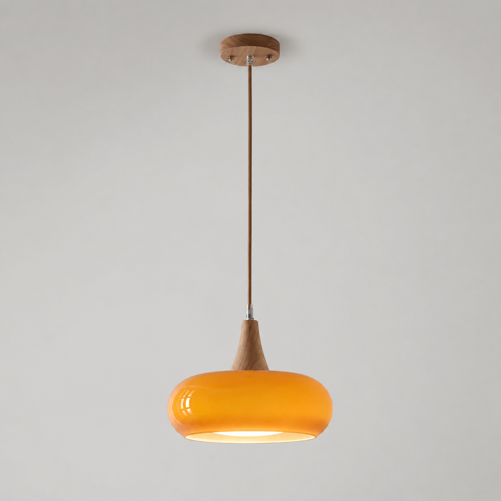Orange pendant light with a rounded shade and wood-look stem hanging against a neutral background.