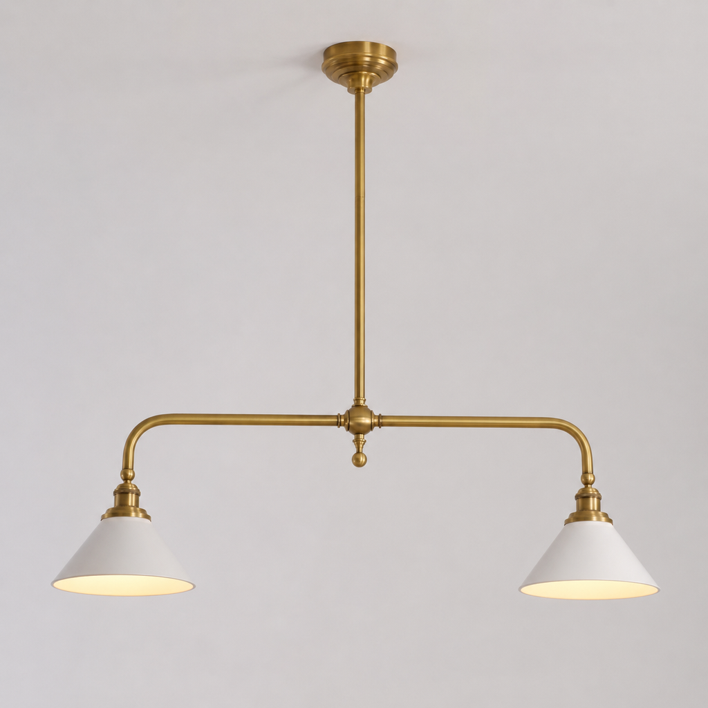 Brass two head pendant light with white cone shades displayed against a plain neutral background.