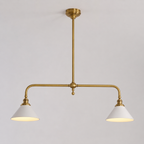 Brass two head pendant light with white cone shades displayed against a plain neutral background.