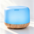 Dome aroma diffuser with blue lighting and a light brown wood grain base