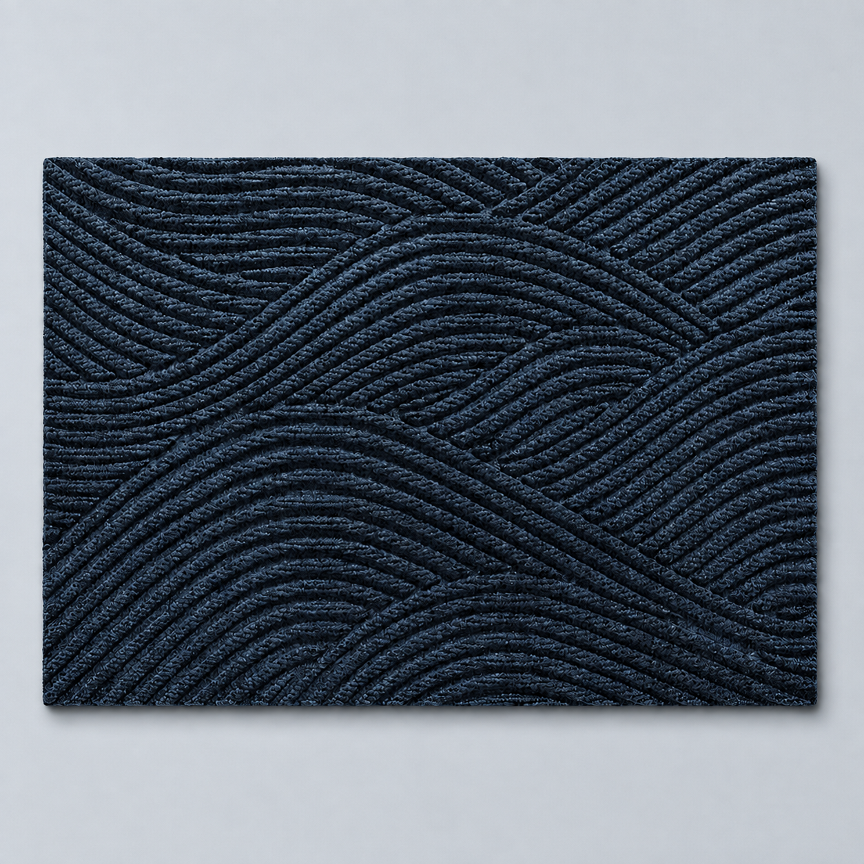 Blue geometric door mat shown alone on a pale blue gray studio background.