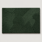 Green geometric door mat shown alone on a soft light gray studio background.
