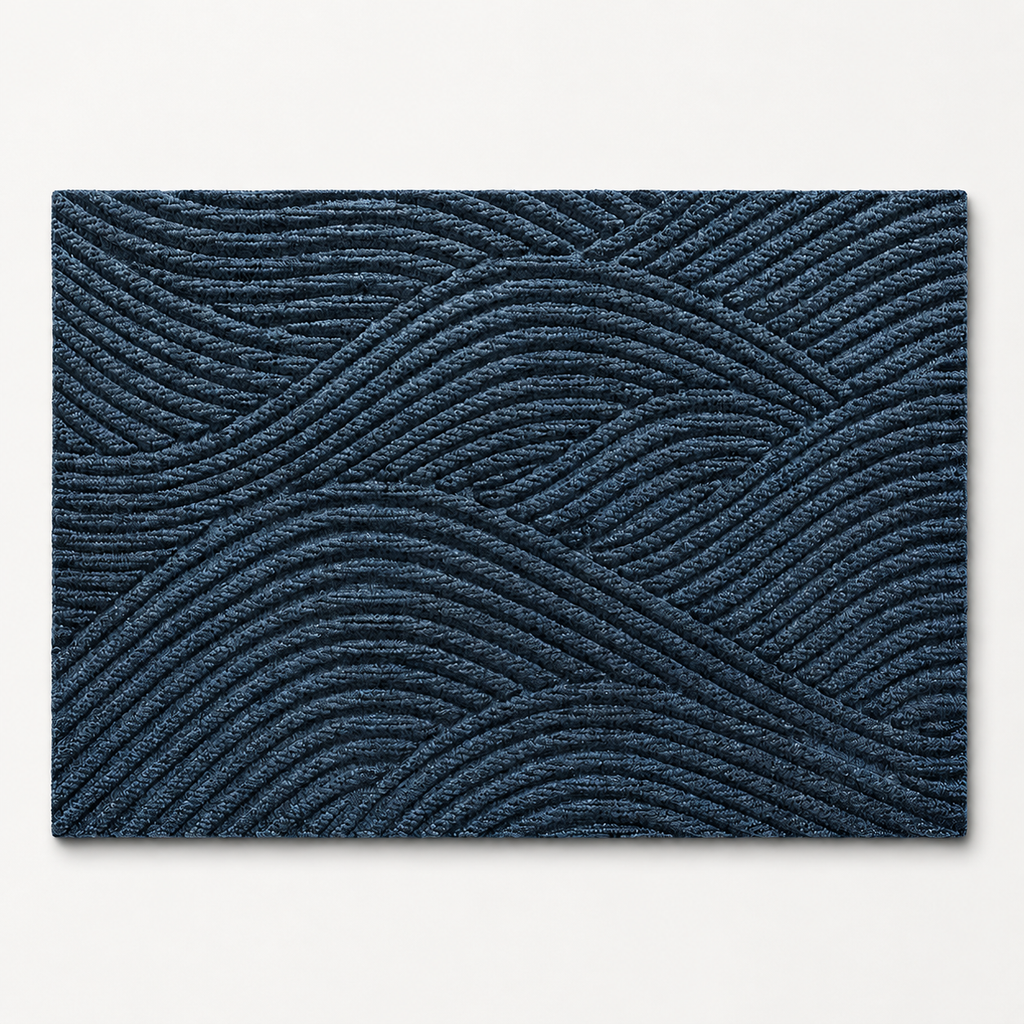Blue geometric door mat shown alone on a cool off white studio background.