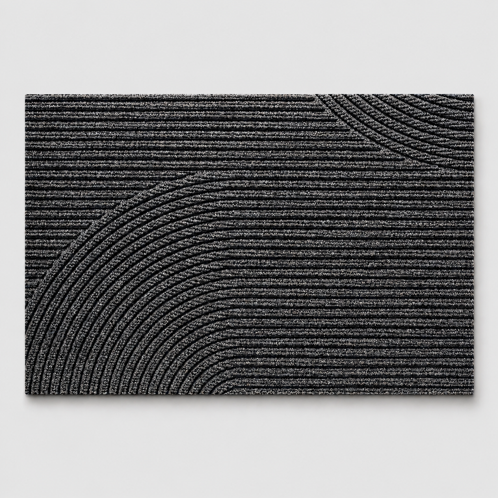 Gray geometric door mat shown alone on a neutral light gray studio background.