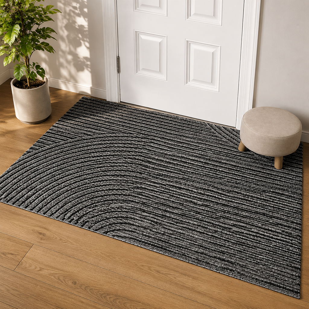 Gray geometric door mat displayed at a white paneled door in late afternoon light.