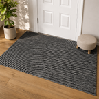 Gray geometric door mat displayed at a white paneled door in late afternoon light.
