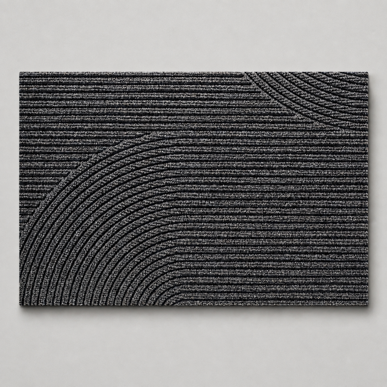 Gray geometric door mat shown alone on a pale stone gray studio background.