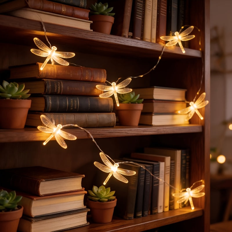Dragonfly fairy lights decorate a bookcase with warm white light.