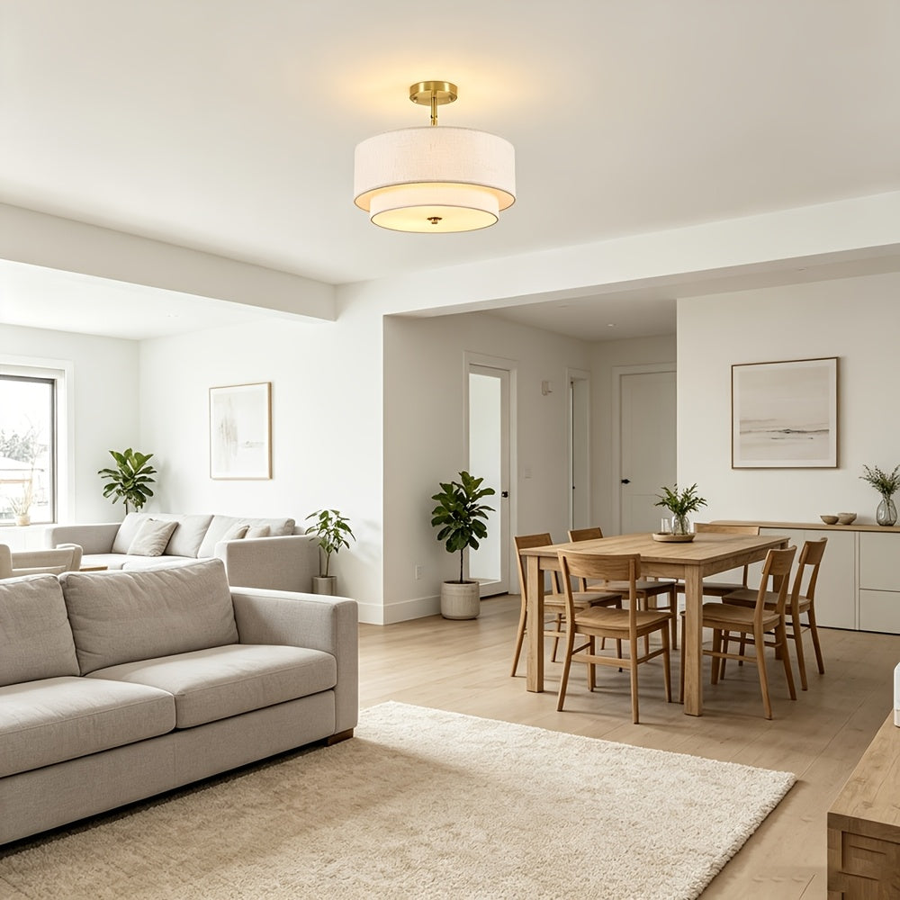 Gold drum ceiling light above a living and dining area.