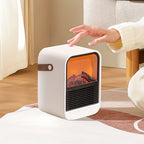 Electric fireplace heater with its carry handle folded down beside a hand.