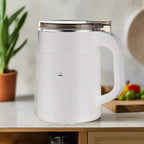 Electric grain mill in white shown upright with its handle and lid visible.
