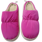Purple electric heated slippers on a white background