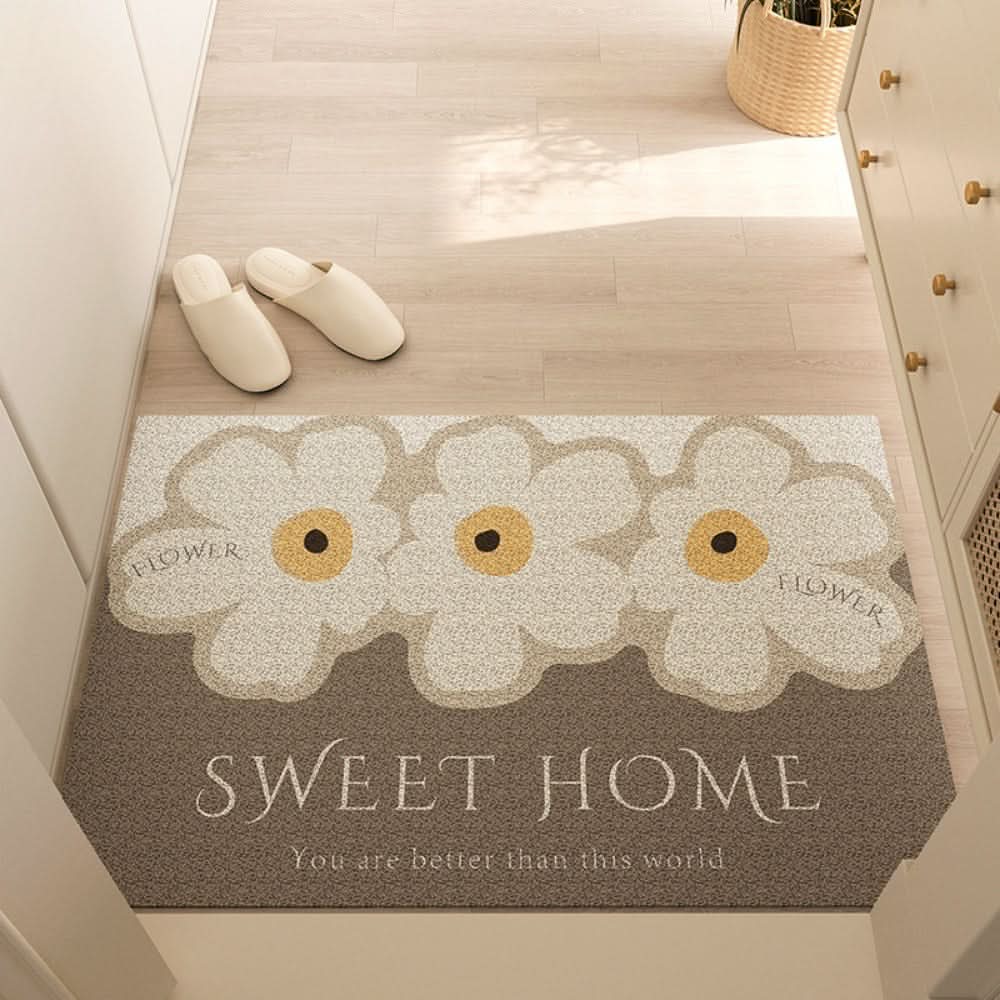 Entry mat with a floral Sweet Home print placed inside a bright doorway.