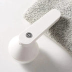 White fabric shaver with a power button on folded material