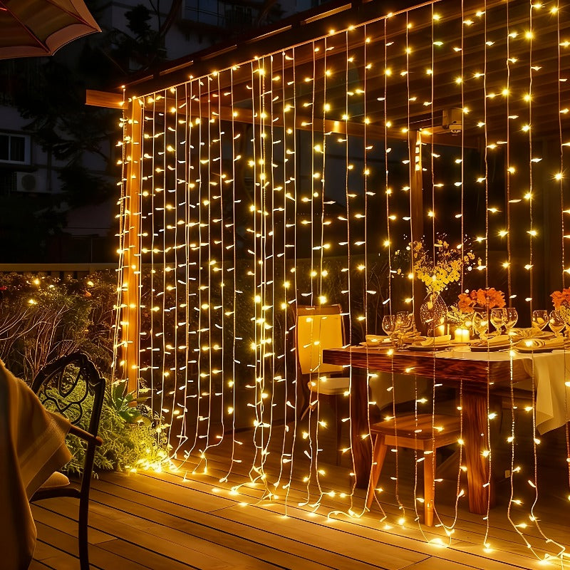 Fairy curtain lights hanging behind a decorated dining table.