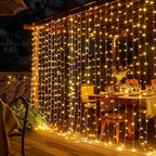 Fairy curtain lights hanging behind a decorated dining table.