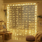 Fairy curtain lights hanging across a bedroom window above a floor cushion.