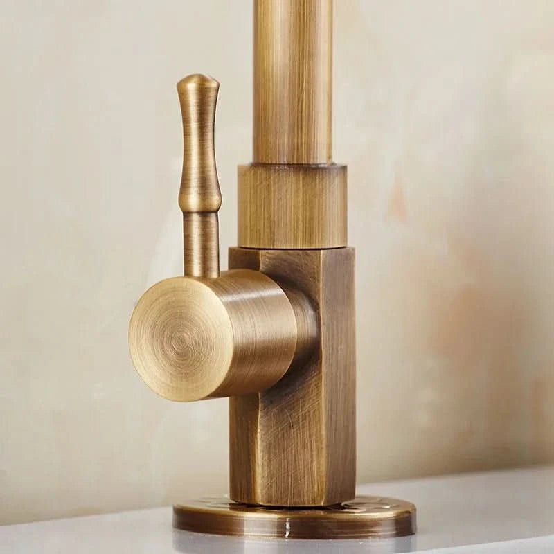 Faucet in antique brass shown close up at the single control handle.