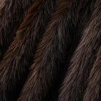Close view of long dark brown pile on the faux fur throw blanket.