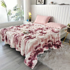 Red and cream faux fur throw blanket spread across a bed.
