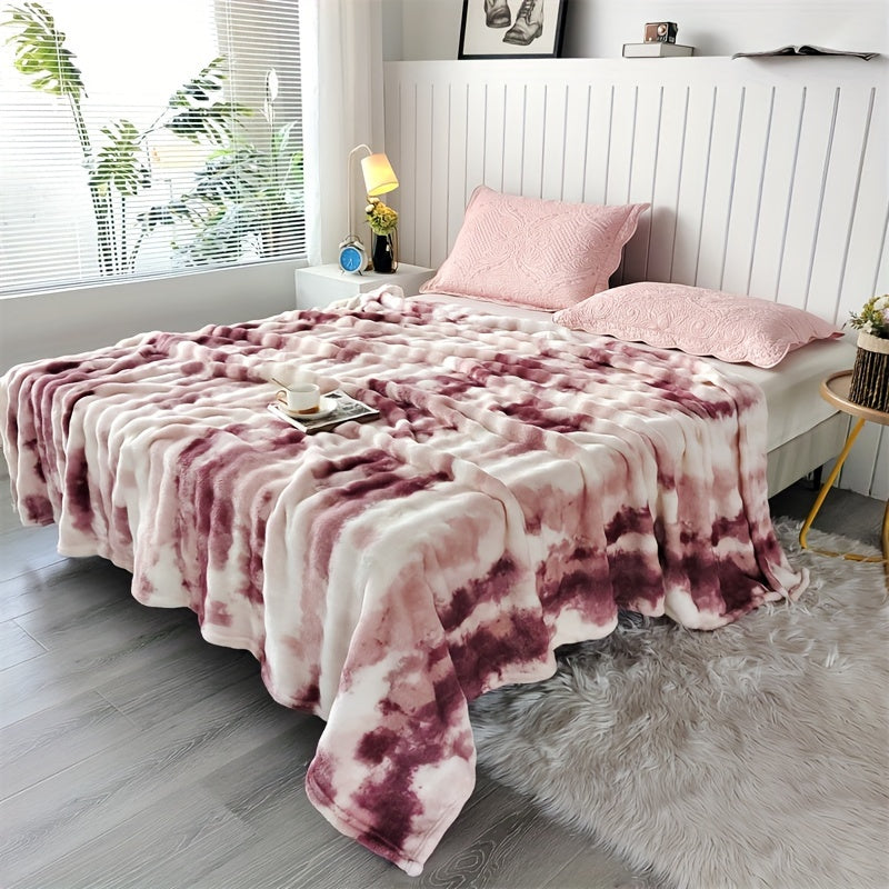 Red and cream faux fur throw blanket spread across a bed.