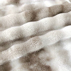 Close view of cream and brown rows on the faux fur throw blanket.