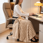 Beige faux fur throw blanket over the knees of a person at a desk