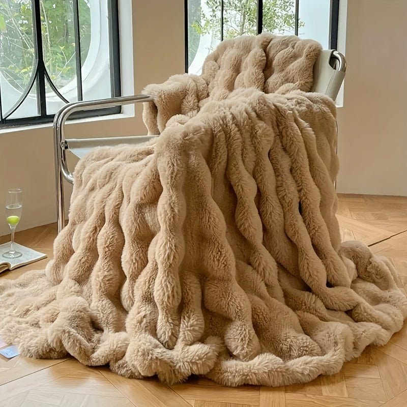 Tan faux fur throw blanket draped over a chair.