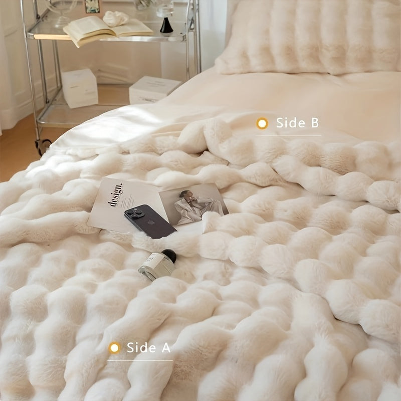 White faux fur throw blanket showing its textured front and smooth reverse.