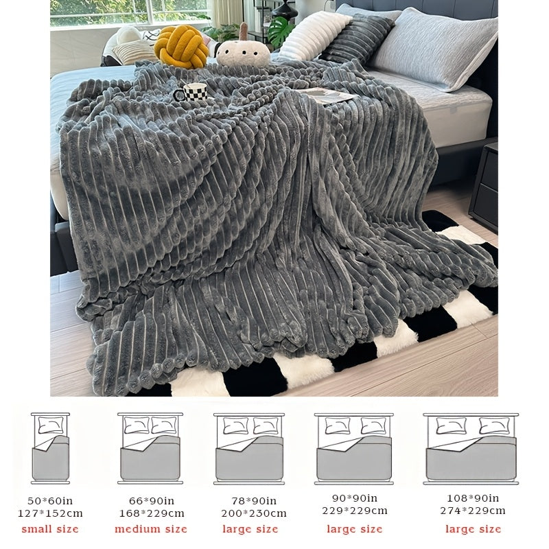 Dark gray faux fur throw blanket on a bed above a size diagram.
