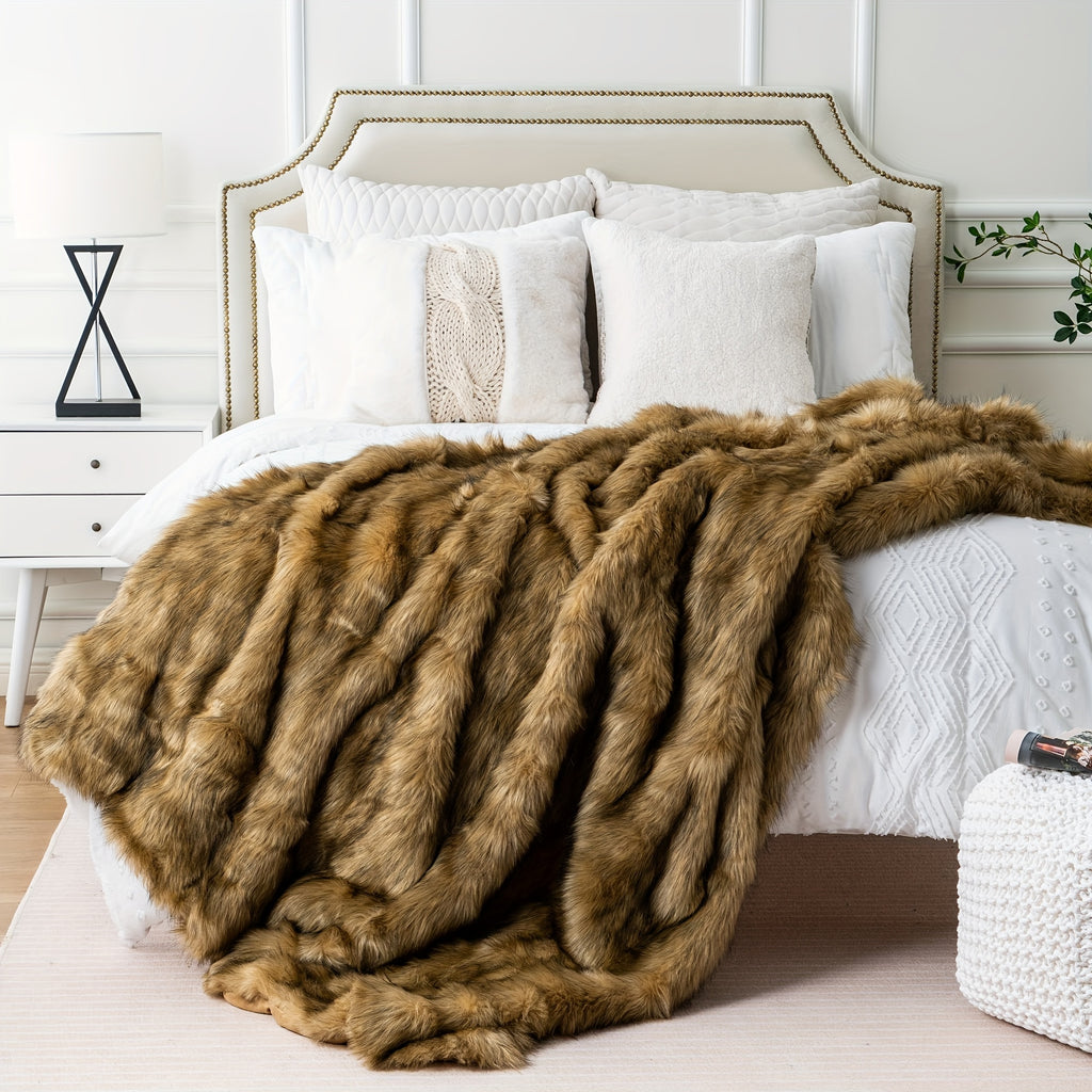 Brown faux fur throw blanket across the foot of a white bed.