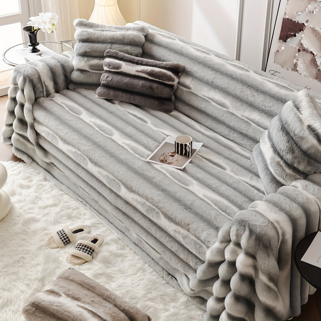 Light gray ribbed faux fur sofa cover draped over a couch.