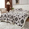 Black and white diamond patterned faux fur blanket spread across a bed.