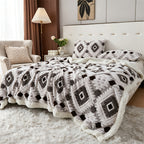 Black and white diamond patterned faux fur blanket spread across a bed.