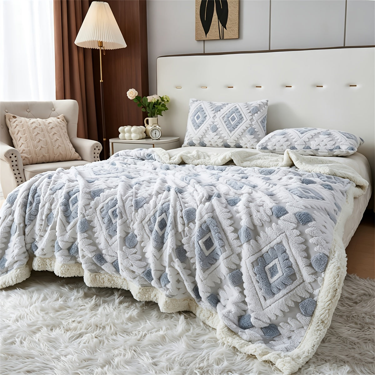 Pale blue and white diamond patterned faux fur blanket across a bed.