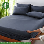 Dark gray fitted sheet displayed on a bed with a bamboo graphic