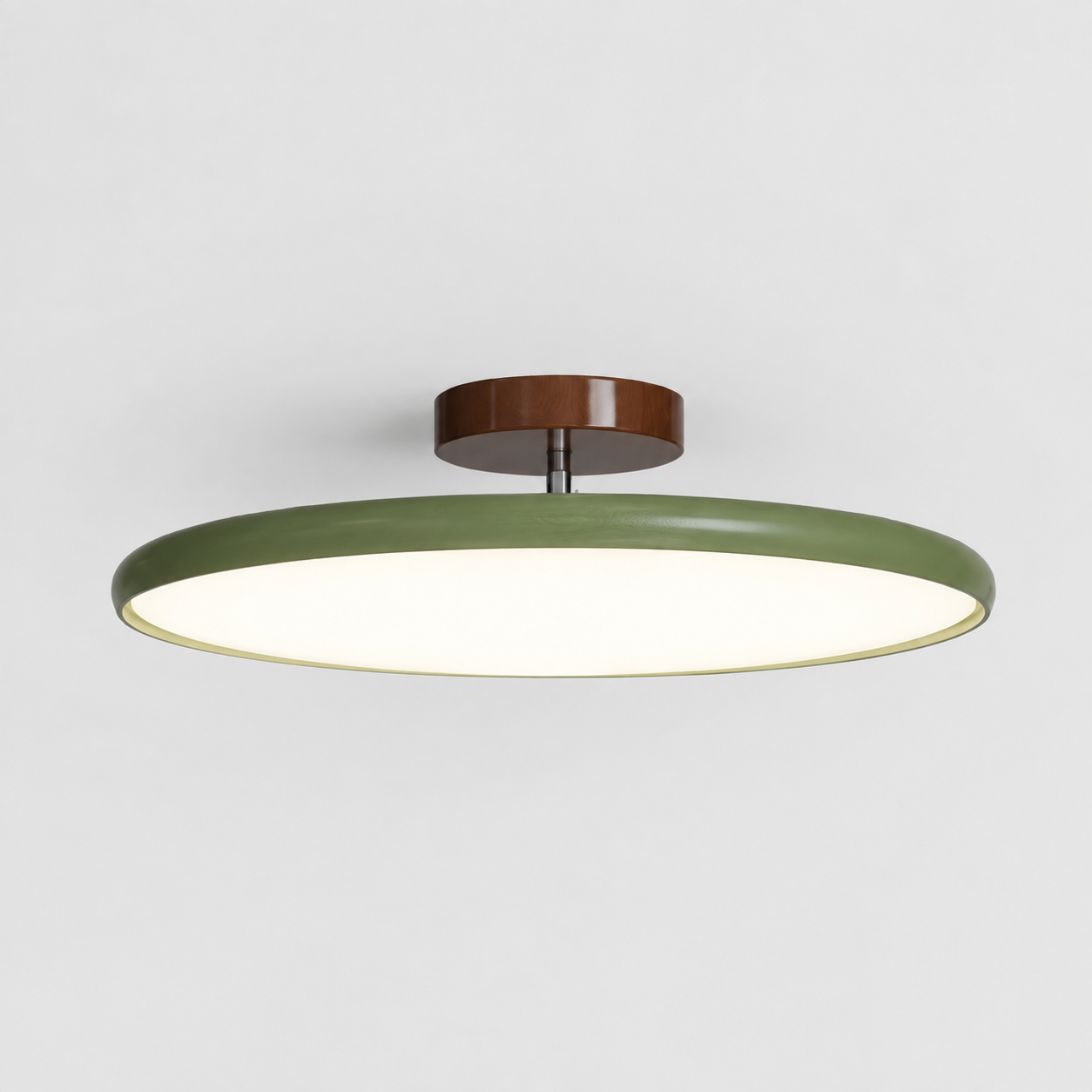 Round flush mount ceiling light with a green rim, brown canopy, and glowing white diffuser.
