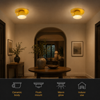 Two yellow flush mount ceiling light fixtures glowing in a warm interior above a table and seating area.