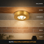Gold flush mount ceiling light displayed across layered wood, tile, brick, and painted surface samples.