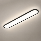 Black oval flush mount ceiling light glowing on a warm gray ceiling.