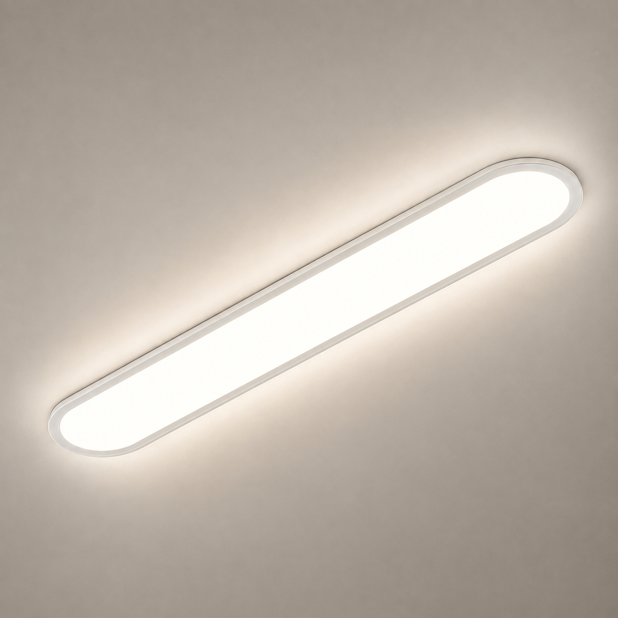 White oval flush mount ceiling light glowing against a light neutral ceiling.